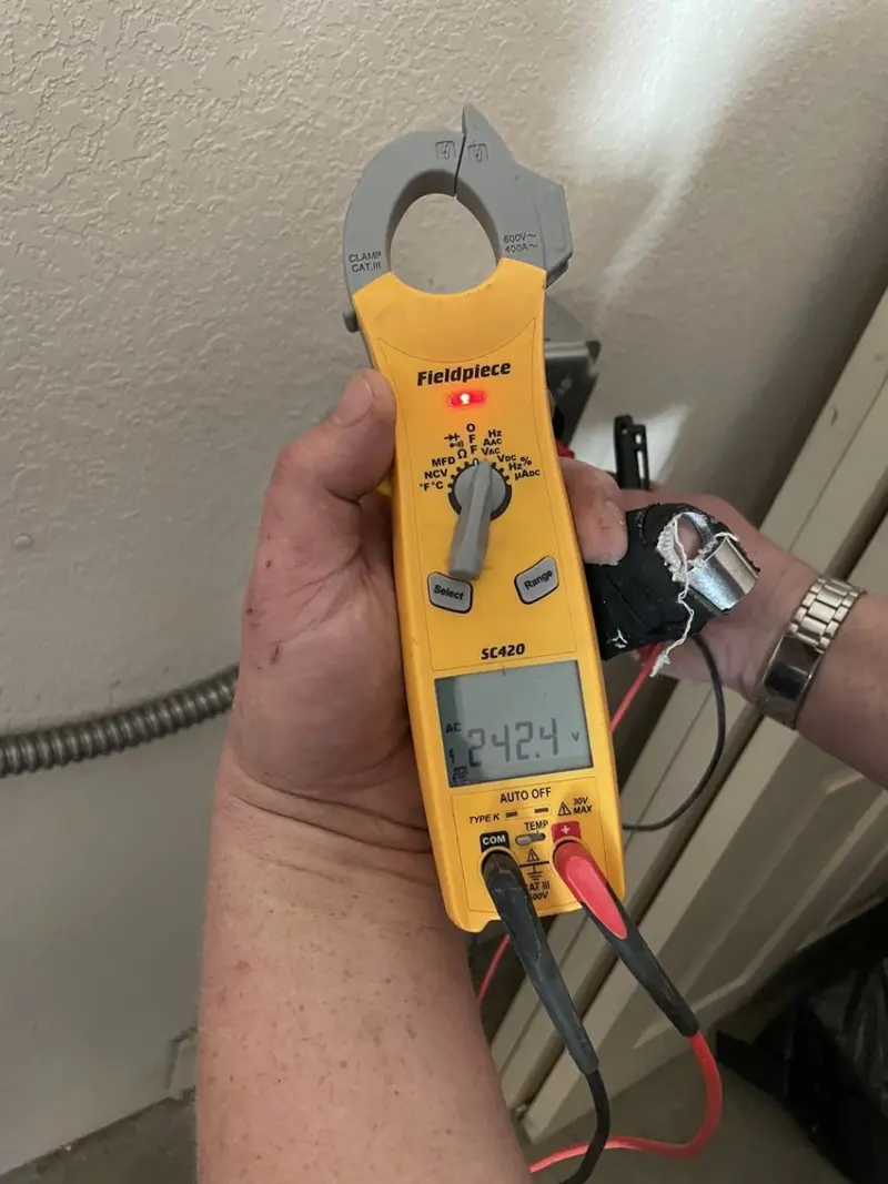 Voltage testing with clamp meter during Ceiling Fan Installation in Clay